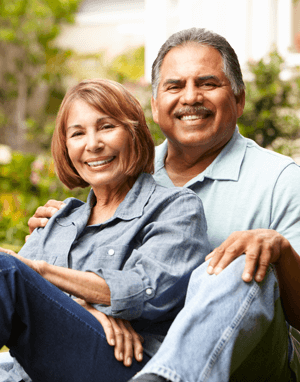 Happy older couple sitting outside